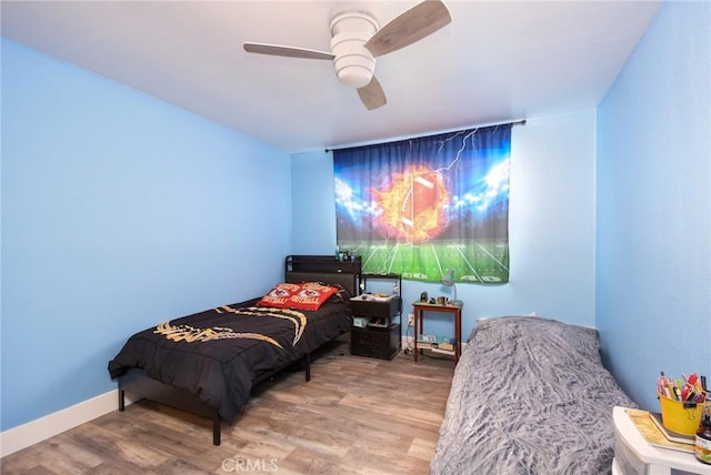 bedroom with hardwood / wood-style floors and ceiling fan