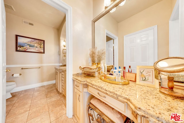 bathroom featuring tile patterned flooring, vanity, and toilet