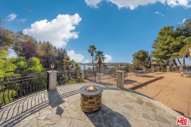 view of patio / terrace with an outdoor fire pit