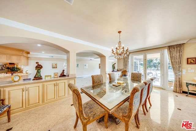 dining room with ornamental molding and a notable chandelier