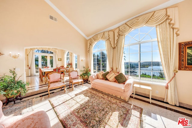 sunroom / solarium featuring a wealth of natural light, a water view, and vaulted ceiling