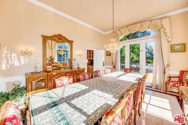 dining area with crown molding, a chandelier, and a high ceiling