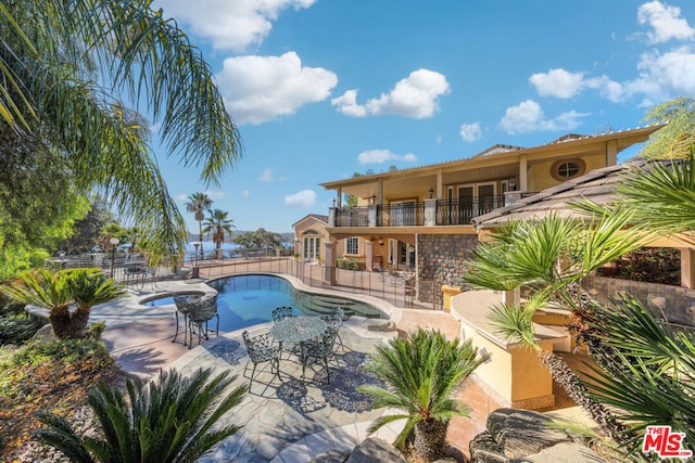 view of pool with an in ground hot tub and a patio