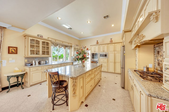 kitchen featuring decorative backsplash, light stone countertops, ornamental molding, stainless steel appliances, and a center island