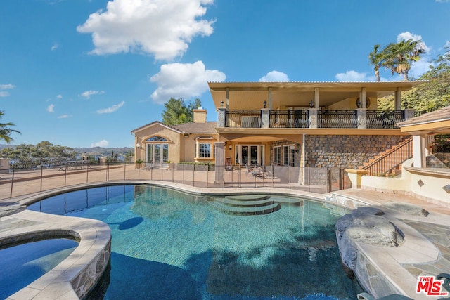 view of swimming pool featuring an in ground hot tub, french doors, and a patio