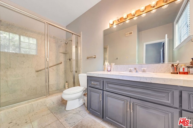 bathroom with vanity, toilet, and an enclosed shower