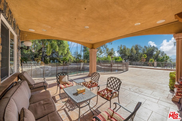 view of patio with a fenced in pool and an outdoor hangout area