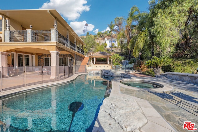 view of pool featuring an in ground hot tub, a gazebo, and a patio area