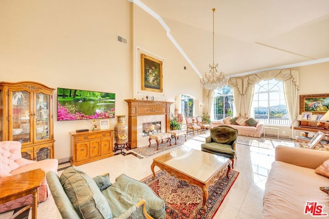 tiled living room with a chandelier and high vaulted ceiling