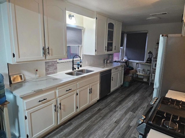 kitchen featuring sink, gas range, light stone counters, stainless steel refrigerator, and dishwasher