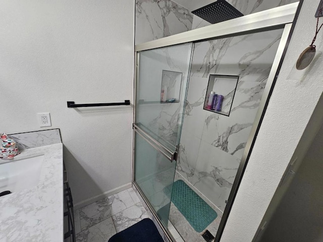 bathroom featuring vanity and a shower with door