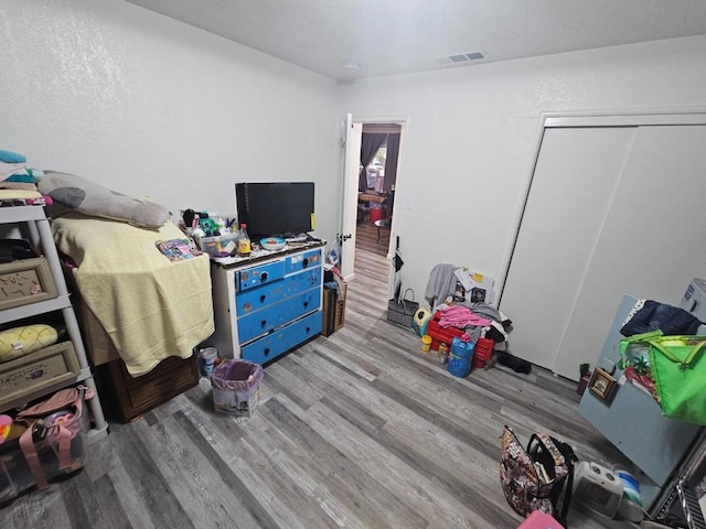 bedroom featuring light hardwood / wood-style floors and a closet