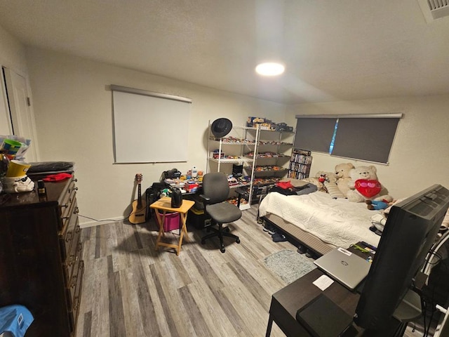 bedroom with wood-type flooring