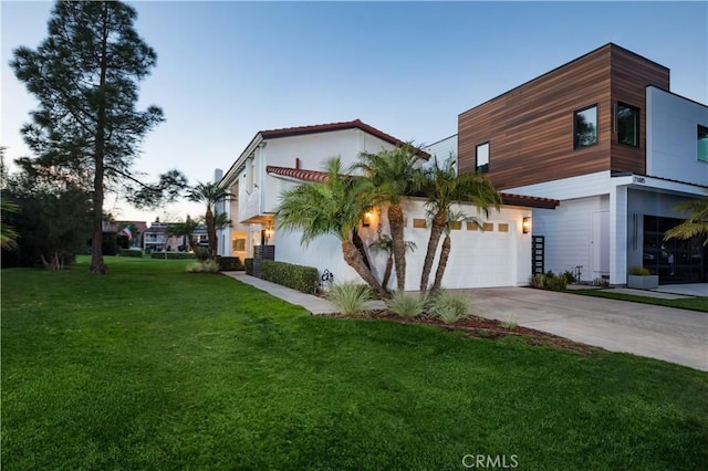 view of front of home featuring a garage and a yard