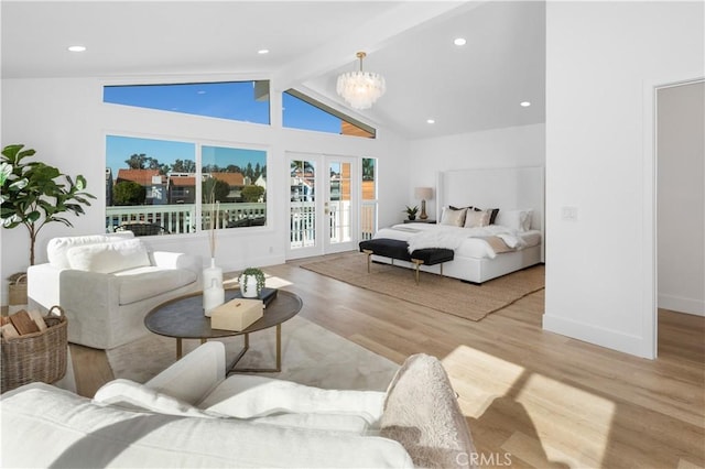 bedroom featuring access to outside, beam ceiling, high vaulted ceiling, a notable chandelier, and light hardwood / wood-style floors