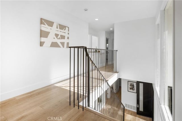 stairway featuring wood-type flooring