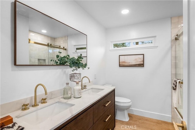 bathroom featuring vanity, hardwood / wood-style flooring, toilet, and an enclosed shower