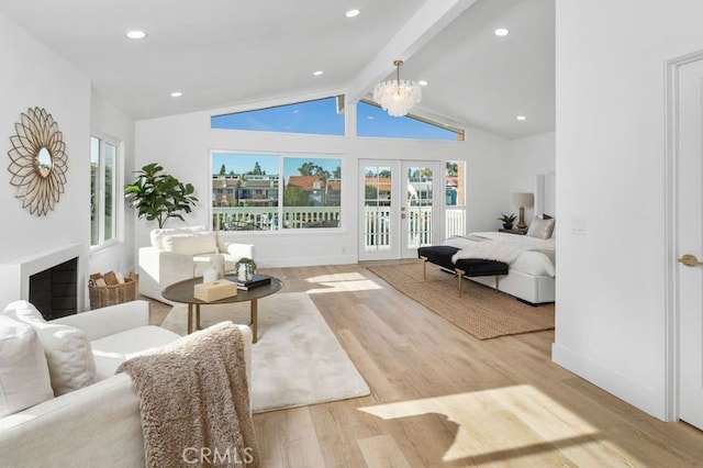 bedroom featuring french doors, hardwood / wood-style flooring, multiple windows, and beam ceiling