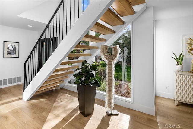 staircase with wood-type flooring