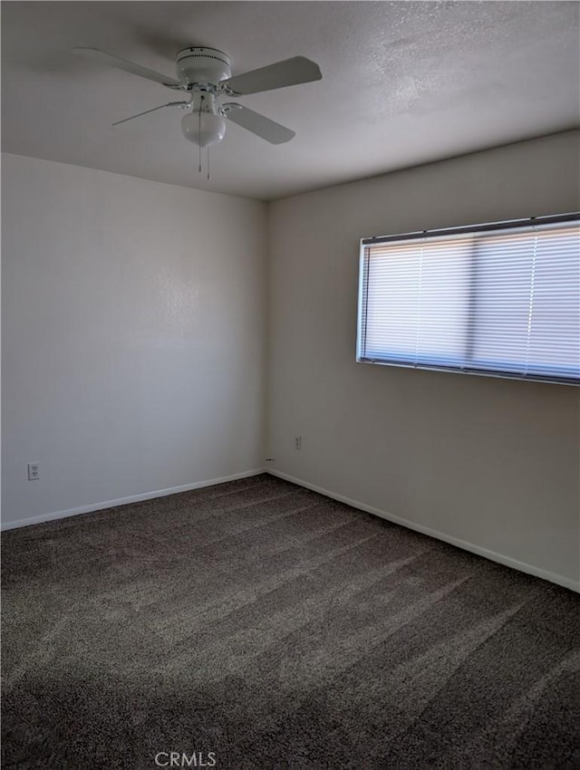 carpeted empty room featuring ceiling fan