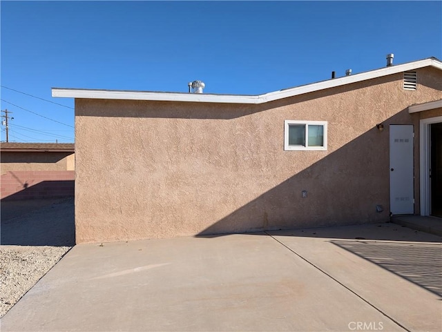 view of property exterior with a patio