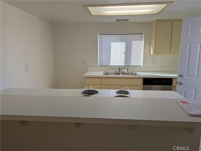 kitchen with dishwasher, range, sink, and cream cabinets