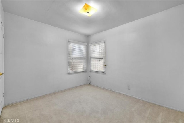 empty room with light colored carpet