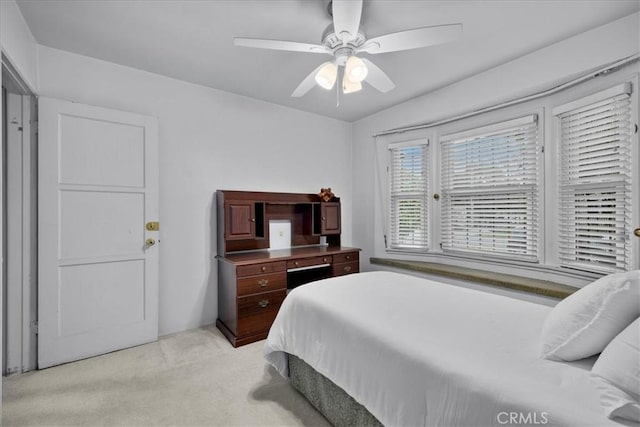 bedroom featuring light colored carpet and ceiling fan