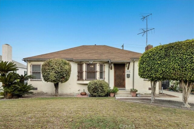 bungalow-style home with a front yard