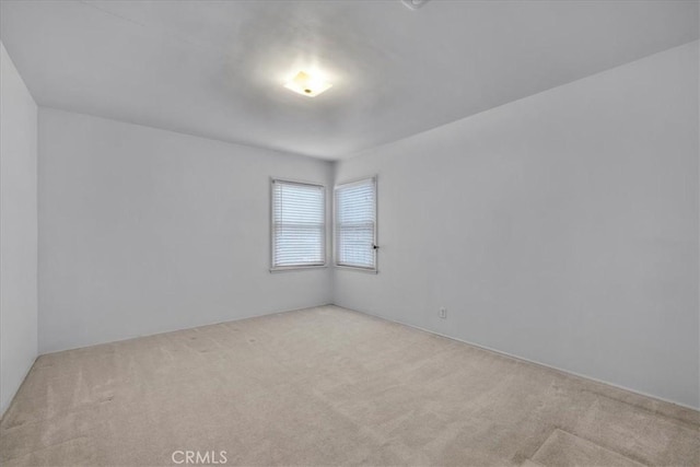 empty room featuring light colored carpet