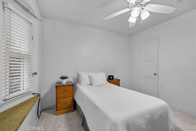 bedroom featuring ceiling fan and light colored carpet