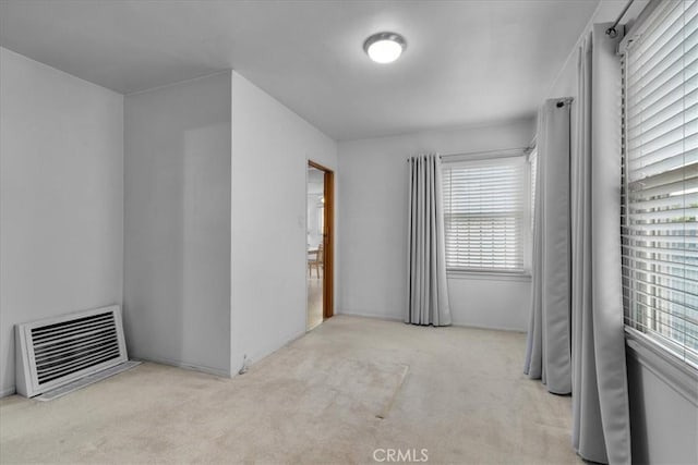 empty room featuring light carpet and visible vents