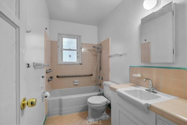 bathroom with bathtub / shower combination, vanity, toilet, and backsplash