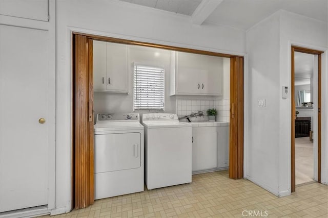 washroom with washer and dryer and cabinet space