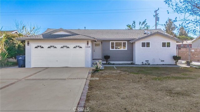 ranch-style home with a garage and a front yard