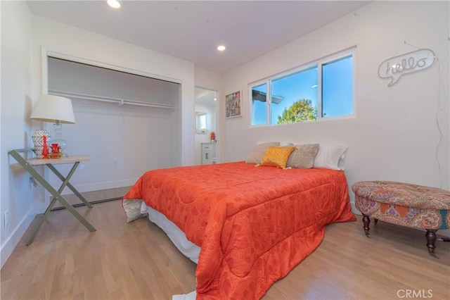 bedroom featuring light wood-type flooring and a closet