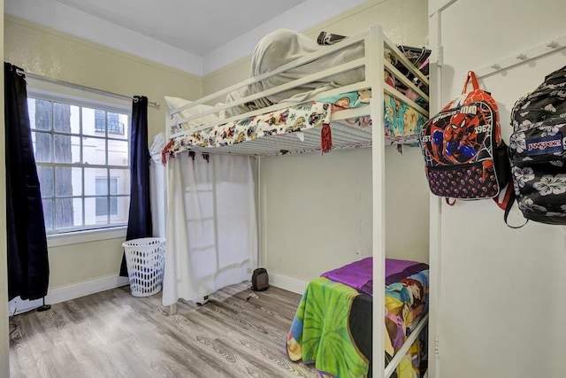 bedroom featuring multiple windows and hardwood / wood-style flooring