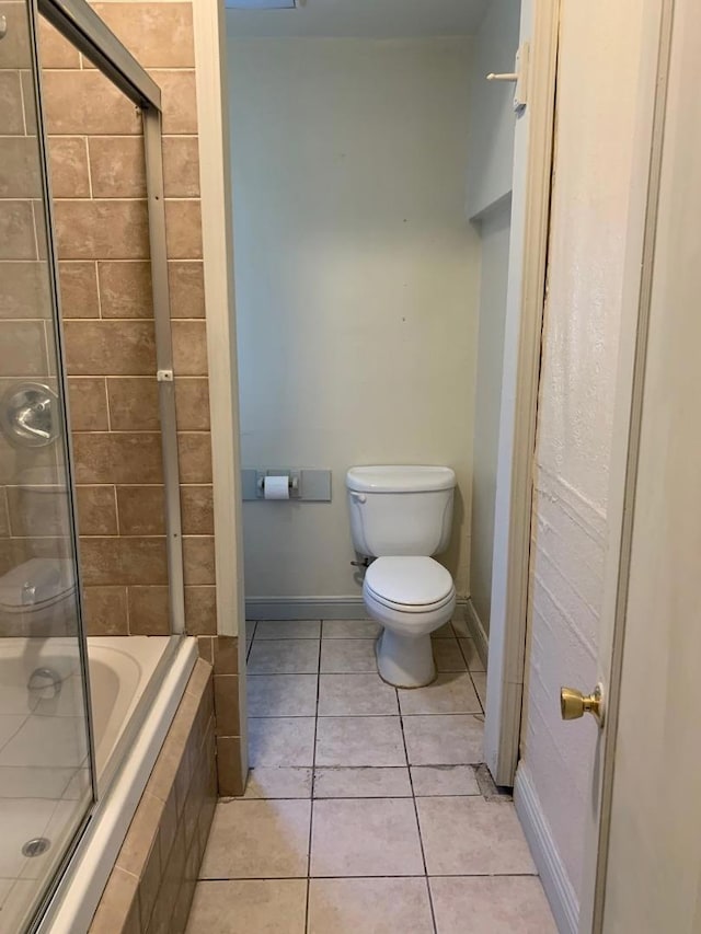 bathroom featuring toilet, independent shower and bath, and tile patterned floors