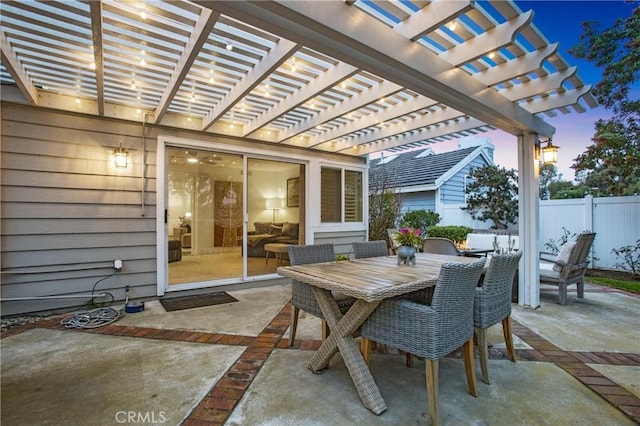 patio terrace at dusk featuring a pergola