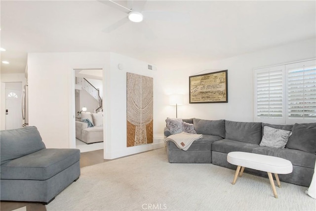 living room featuring carpet flooring and ceiling fan