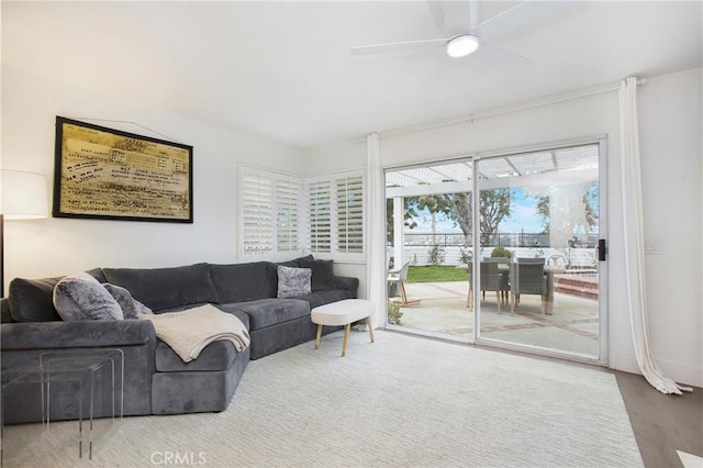 living room featuring hardwood / wood-style floors and ceiling fan