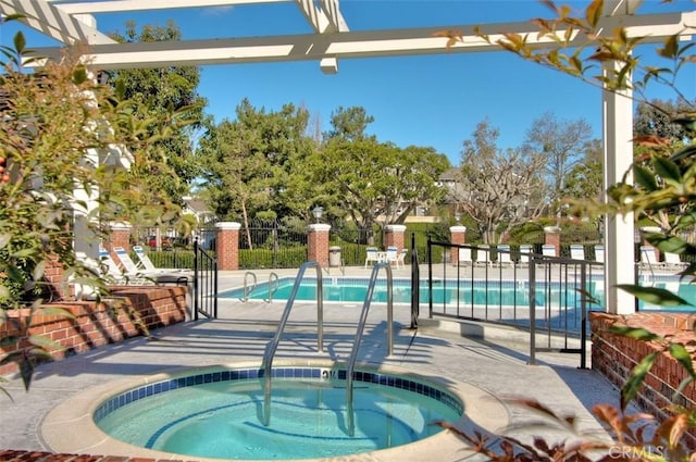 view of pool with a patio and a hot tub