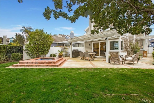 rear view of house with a patio area, a pergola, and a yard