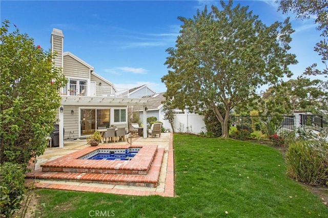 back of property with a pergola, a patio area, and a yard