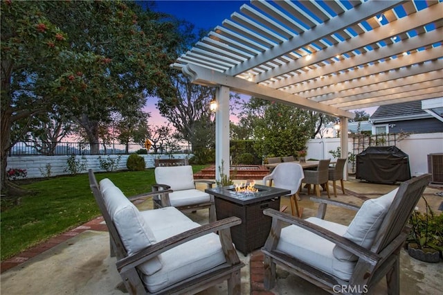 patio terrace at dusk with area for grilling, a yard, and an outdoor fire pit