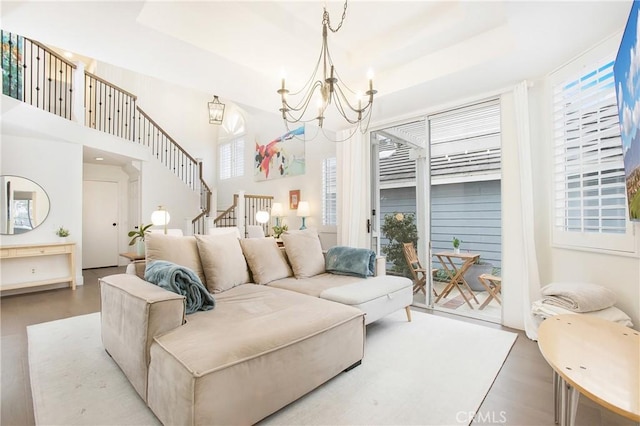 bedroom with access to exterior, hardwood / wood-style flooring, and a notable chandelier