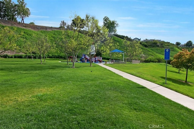 surrounding community with a yard and a playground