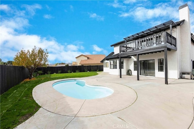 view of pool with a yard and a patio