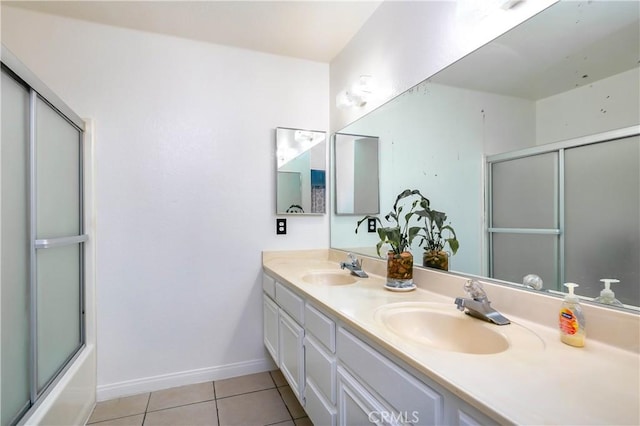 bathroom with tile patterned flooring, vanity, and combined bath / shower with glass door