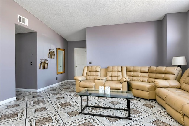 living room with tile patterned floors, a textured ceiling, and vaulted ceiling